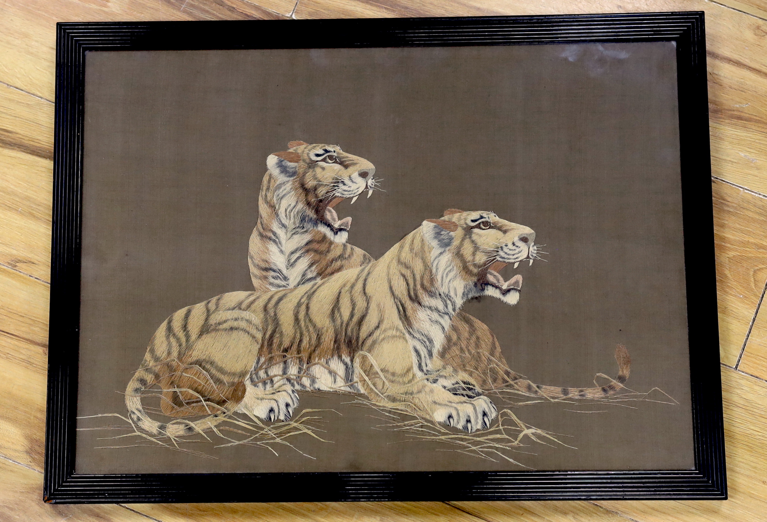 A Japanese silk panel embroidered with two tigers, 53 x 39cm